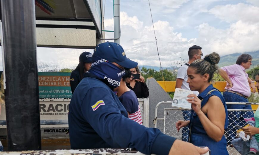 Mujer migrante presenta su documento en la frontera